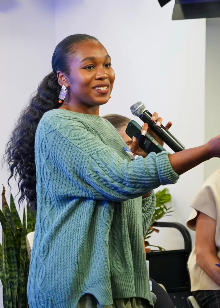 Kariel speaking into a microphone at NY Climate Week