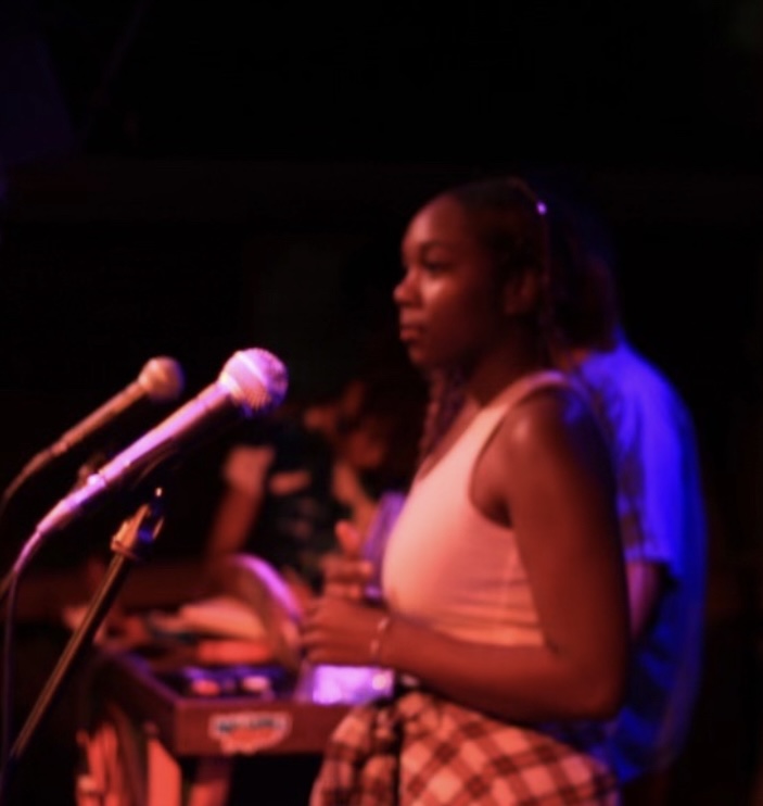 Kariel beside microphones at a DOPENMIC event
