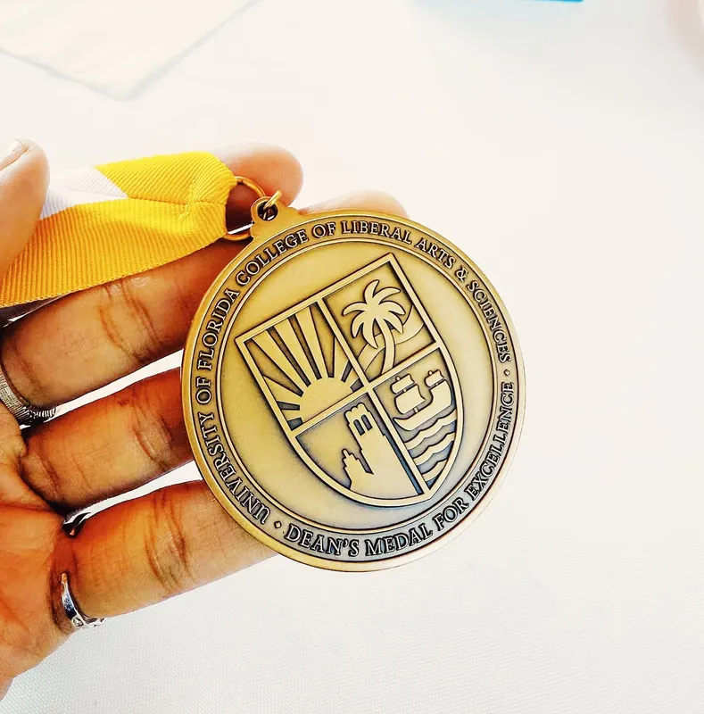 Kariel holding the University of Florida Dean’s Medal for Excellence