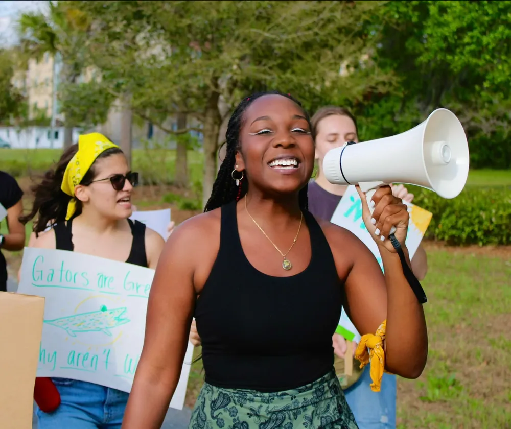 Kariel leading a Sunrise Movement rally with a megaphone